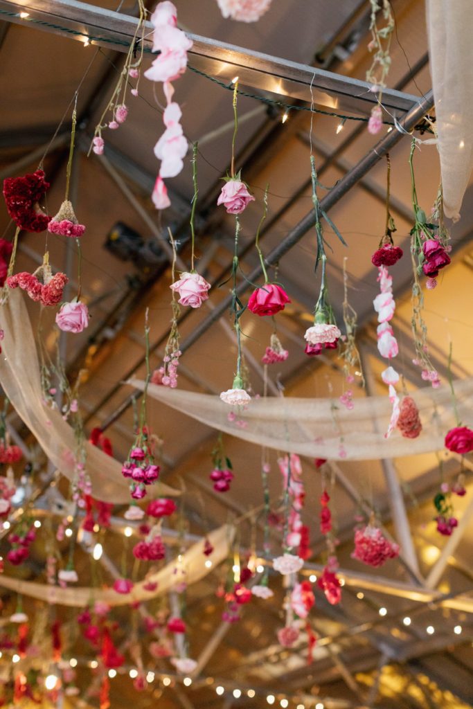 Love is in the Air styled shoot and bespoke bridal event at the Horticulture Center, custom ceiling treatment with hanging flowers in shades of pink and accents of gold tulle. Event design and florals by Sebesta Design. Photography by Emily Wren Photography. 