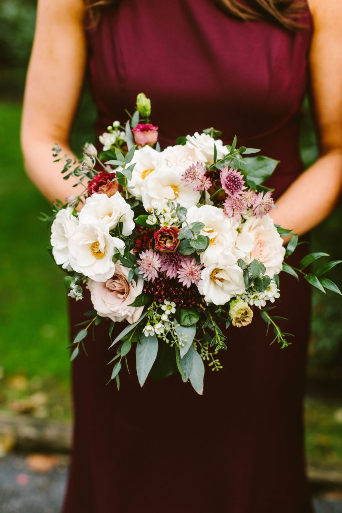 Elegant, Ethereal and Autumnal Wedding Bridesmaid Bouquet of taupe quicksand roses, astrantia, white majolica spray roses, burgundy lisianthus, garden greenery and jasmine vine Designed by Sebesta Design, Photography by Redfield Photography