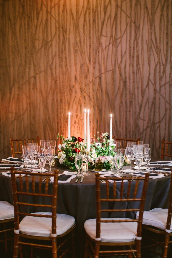 Elegant, Ethereal and Autumnal Pomme Radnor Wedding Reception. Table centerpiece composed of a vignette of small arrangements varying in size accompanied by romantic ivory taper candles. Designed by Sebesta Design, Photography by Redfield Photography
