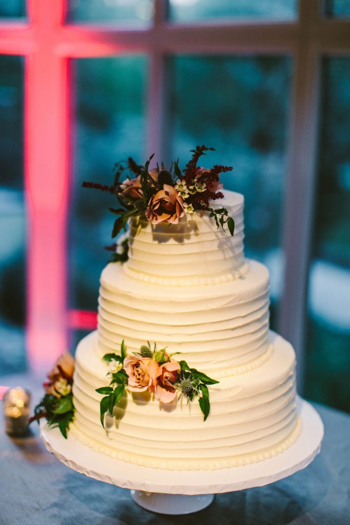 Elegant, Ethereal and Autumnal Pomme Radnor Wedding cake accented with coordinating flowers and garden greens. Designed by Sebesta Design, Photography by Redfield Photography