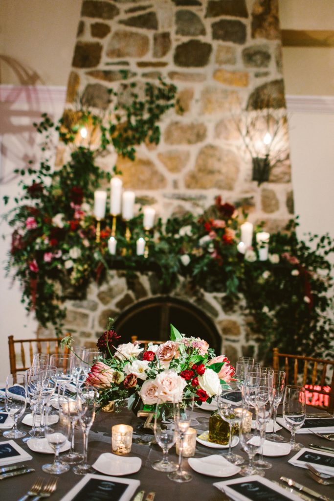 Elegant, Ethereal and Autumnal Pomme Radnor Wedding Reception. Asymmetrical centerpiece in a gold footed compote bowl composed of roses, garden roses, dahilas, lisianthus, anemones, laceflower, spray roses, king protea and garden greens. Designed by Sebesta Design, Photography by Redfield Photography