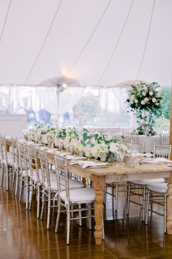 Classic Timeless Garden Party under Sailcloth tent, wood farmhouse tables featuring lush white floral arrangements and mercury votive cups. Event design by Sebesta design at Congress Hall in Cape May, NJ, photography by Rachel Pearlman Photography