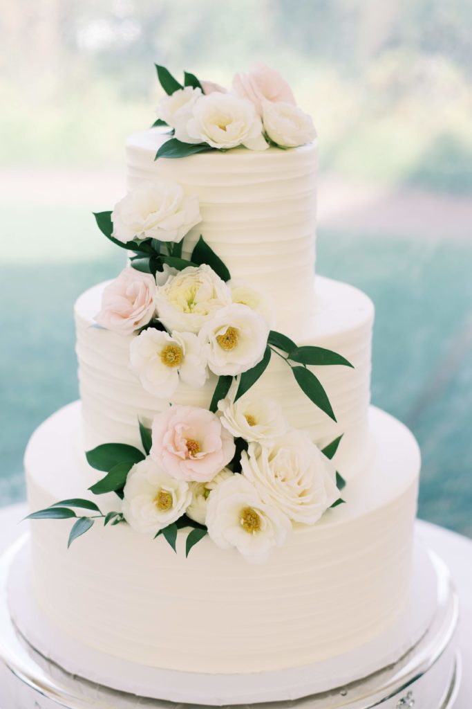 Classic Timeless Garden Party wedding cake with floral and greenery accents cascading down. Event design by Sebesta design at Congress Hall in Cape May, NJ, photography by Rachel Pearlman Photography