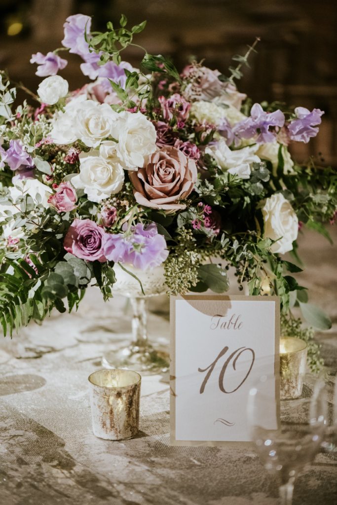 Textural winter wedding compote centerpiece featuring japanese sweet peas, roses, garden roses, astrantia, fern, eucalyptus, and ruscus by Sebesta Design. Photo by M2 Photography
