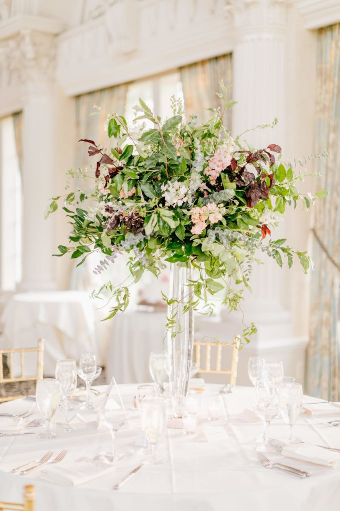 Fall wedding organic tall centerpiece comprised of mostly foliage, larkspur, jasmine vine and stock at the Ashford Estate by Sebesta Design. Photo by Emily Wren Photography