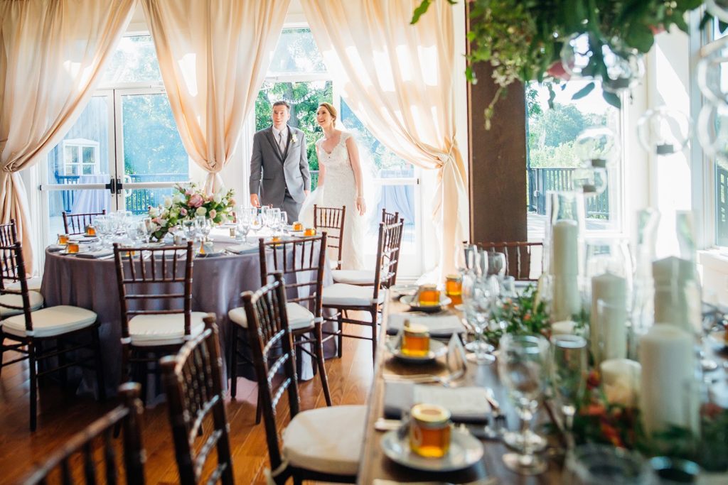 Bride and Groom’s first look at their elegant secret garden inspired wedding reception with immersive floral installations and soft draping at the Barley Sheaf Farm, Designed by Sebesta Design. Photography by Juliana Laury Photography.