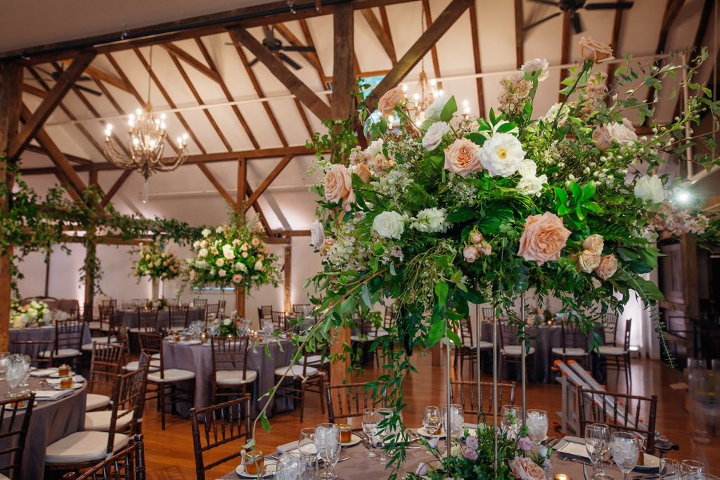 Elegant Secret Garden Wedding Reception, elevated centerpieces featuring draping greenery and garden blooms in shades of ivory, peach and coral at The Inn at Barley Sheaf Farm by Sebesta Design. Photography by Juliana Laury Photography
