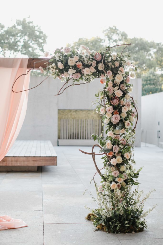 Boho Garden Summer Wedding Asymmetrical Ceremony Arch by Sebesta Design at the Barnes Foundation. Photography by Love Me Do Photography