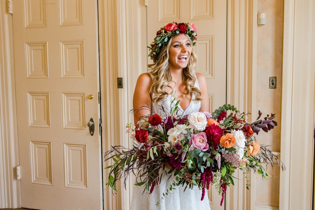 Bold Boho Organic Bridal Bouquet featuring orchids, garden roses, dahlias, chocolate lace flower, spray roses, ranunculus, plume celosia, hanging amaranthus and garden foliage with matching floral bridal head wreath designed by Sebesta Design. Photographed by The Caffeinated Photographer.