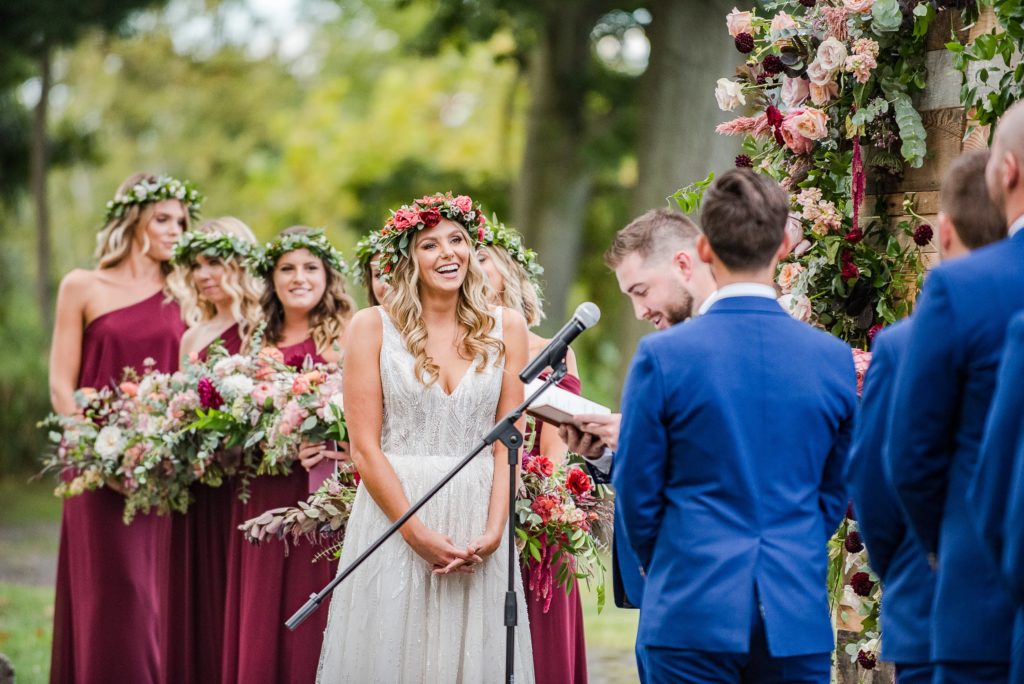 Bold Boho Organic Wedding bridal party during ceremony at Glen Foerd on the Delaware by Sebesta Design. Photographed by The Caffeinated Photographer.