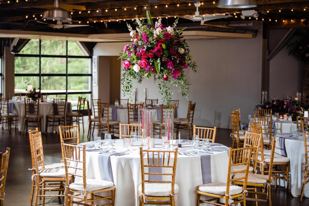 Fun Pink Garden wedding reception hanging centerpiece with garden roses, spray roses, lisianthus, ranunculus, and garden greenery at John James Audubon Center by Sebesta Design photographed by Morby Photography