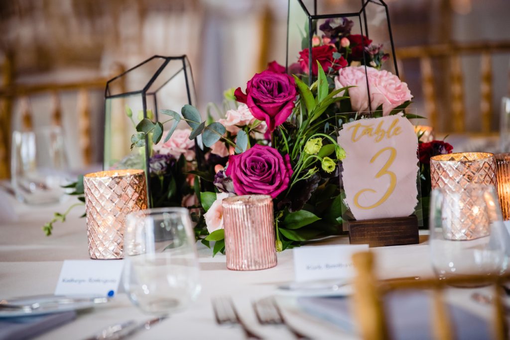 Fun Pink Garden wedding reception centerpiece with flowers, geometric glass terrariums, hand-painted table numbers and blush mercury votive cups at John James Audubon Center by Sebesta Design photographed by Morby Photography